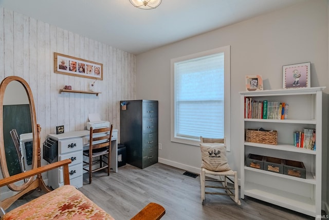 home office with light hardwood / wood-style flooring