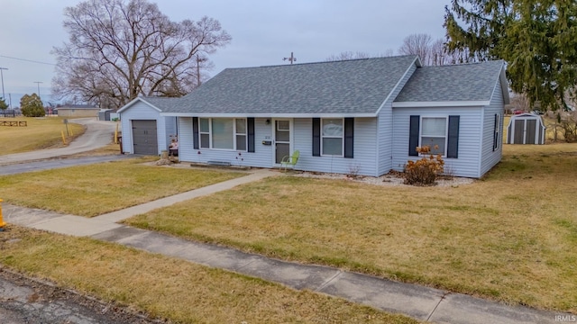 single story home with a garage, a storage shed, and a front lawn