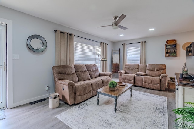 living room with ceiling fan and light wood-type flooring