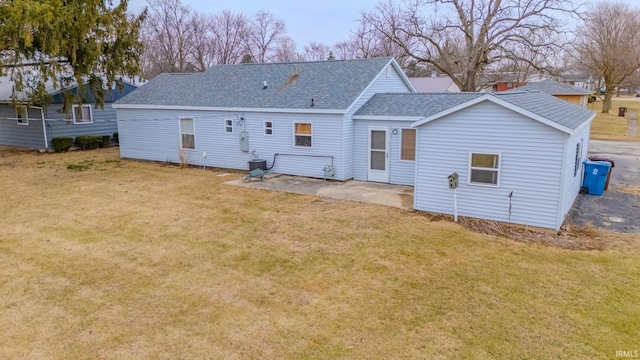 back of house featuring a yard, central AC, and a patio