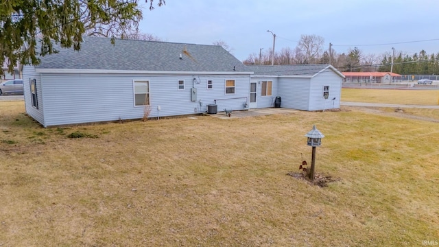 back of house featuring a yard, a patio area, and central air condition unit