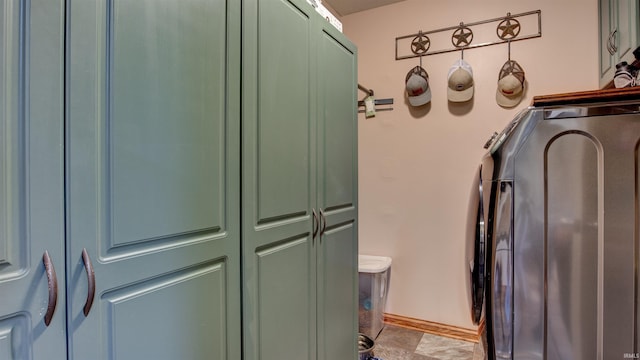 laundry area featuring cabinets and washing machine and dryer