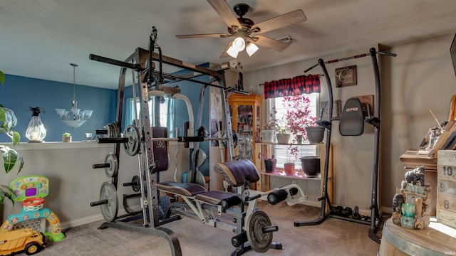 workout room featuring ceiling fan and carpet