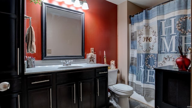 bathroom featuring vanity, a shower with shower curtain, and toilet