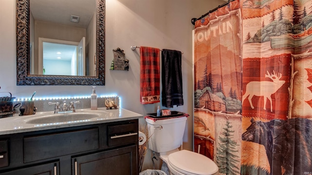 bathroom featuring vanity and toilet