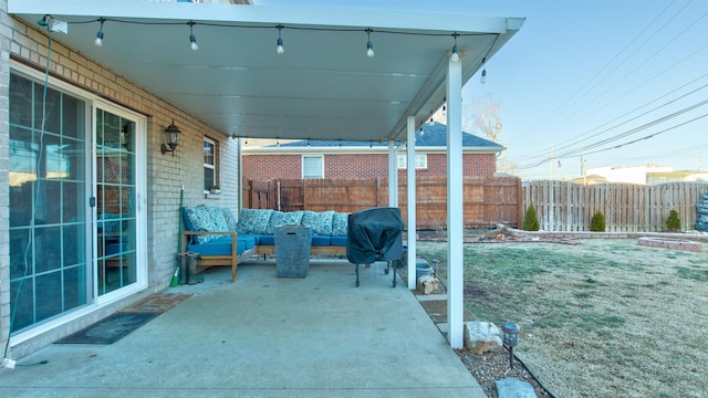 view of patio with area for grilling and outdoor lounge area