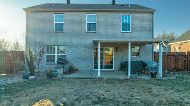 back of house featuring a yard and a patio area