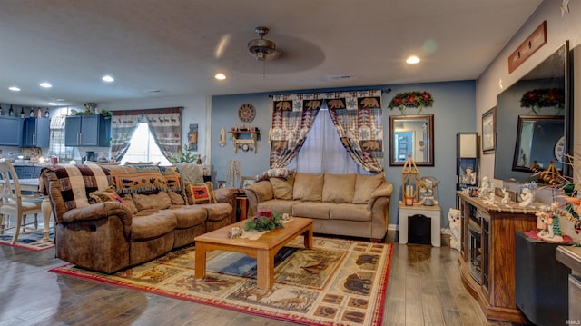 living room featuring hardwood / wood-style flooring and ceiling fan