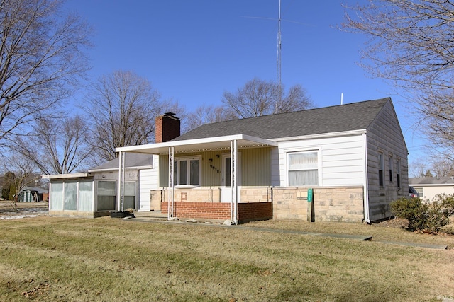 view of front facade with a sunroom, covered porch, and a front yard