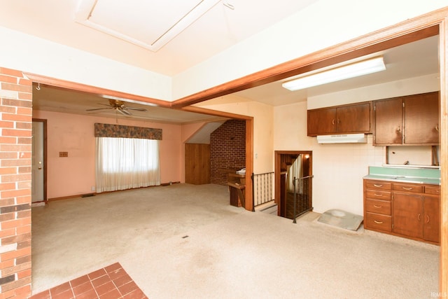 kitchen featuring light carpet and ceiling fan