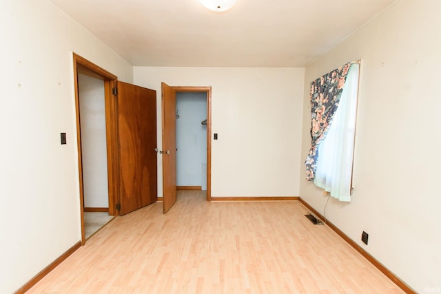 unfurnished room with light hardwood / wood-style flooring