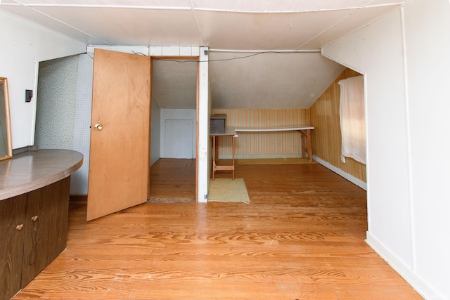 bonus room featuring vaulted ceiling and light hardwood / wood-style flooring