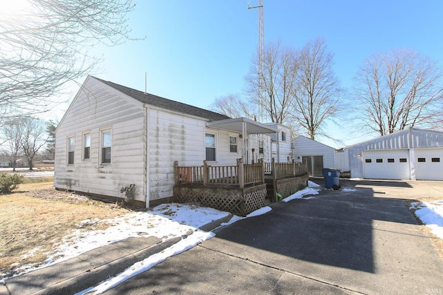 view of front of property featuring a garage and an outdoor structure