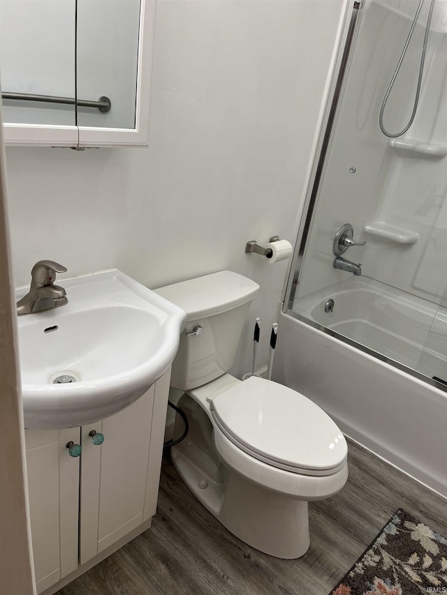 full bathroom with hardwood / wood-style flooring, toilet, sink, and shower / bathing tub combination