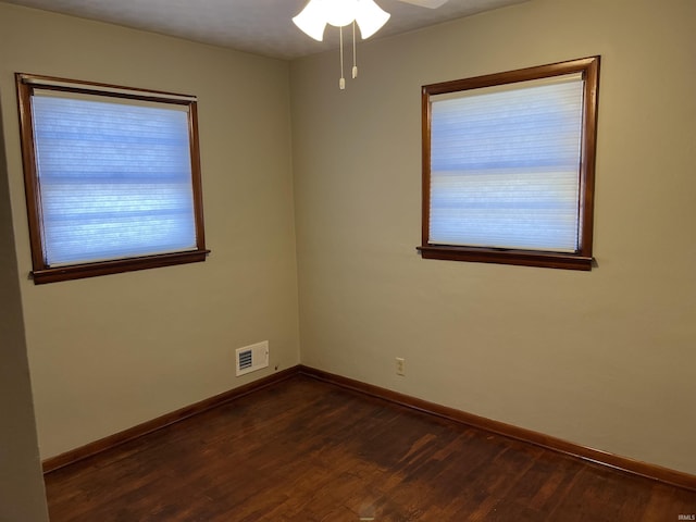 spare room with dark hardwood / wood-style flooring