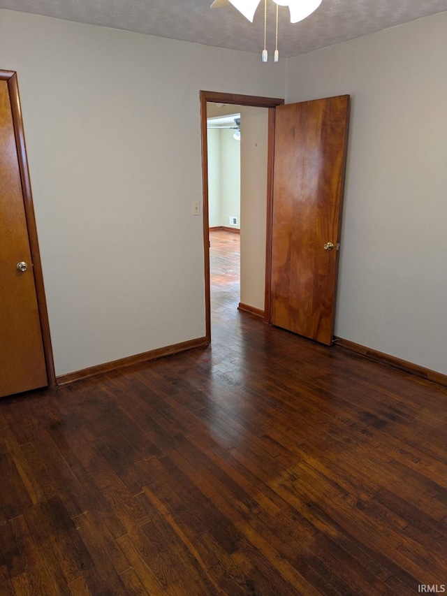 unfurnished room featuring dark hardwood / wood-style flooring and ceiling fan