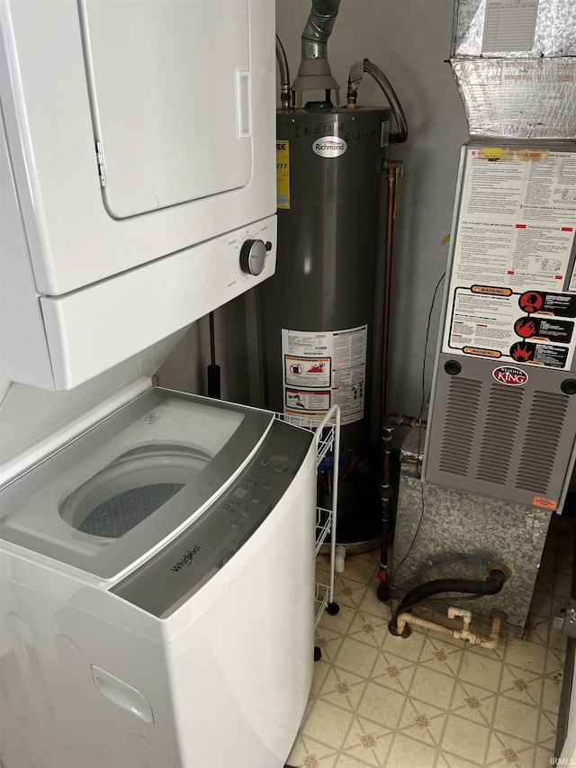 laundry area featuring stacked washer / dryer and gas water heater