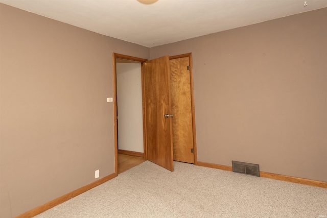 empty room with light colored carpet