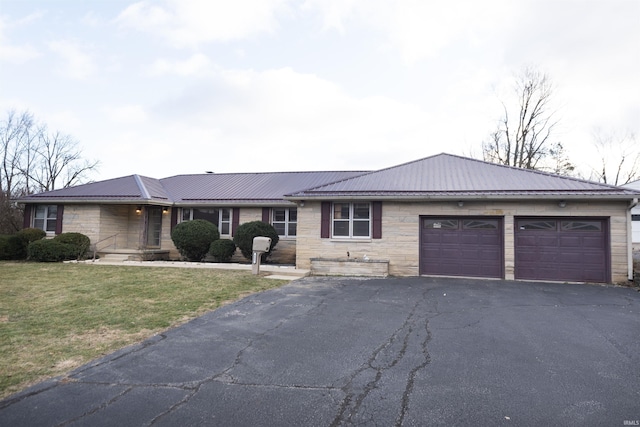 ranch-style home with a garage and a front lawn