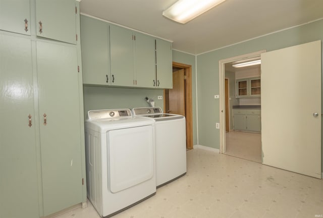 laundry room featuring independent washer and dryer and cabinets