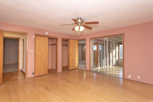 unfurnished room with ceiling fan and light wood-type flooring