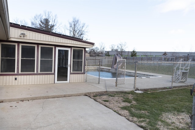 view of pool with a patio area and a water slide