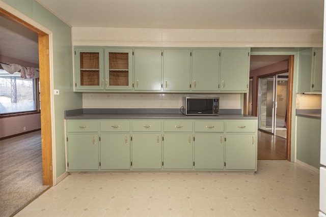 kitchen with green cabinetry and decorative backsplash