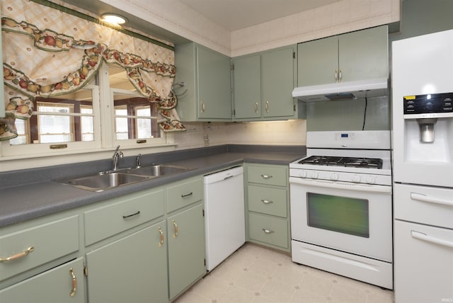 kitchen with sink, white appliances, and green cabinets