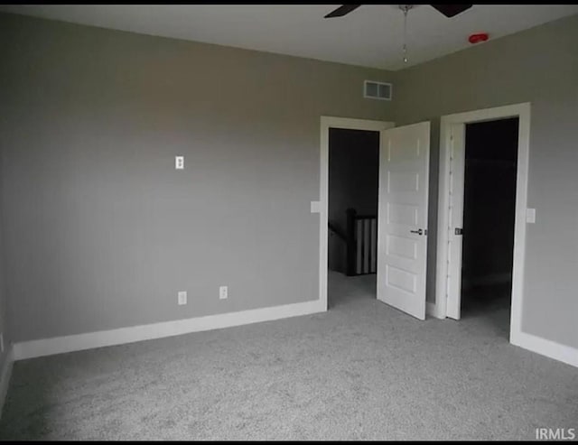 unfurnished bedroom featuring light carpet