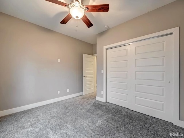 unfurnished bedroom featuring ceiling fan, a closet, and carpet