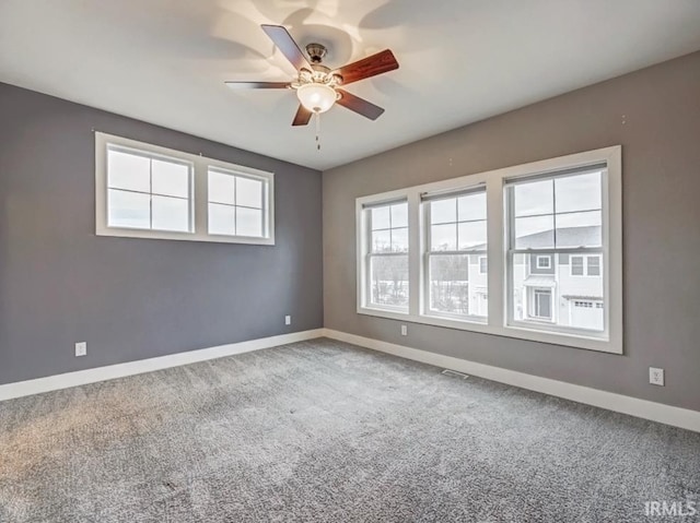 unfurnished room with carpet and ceiling fan