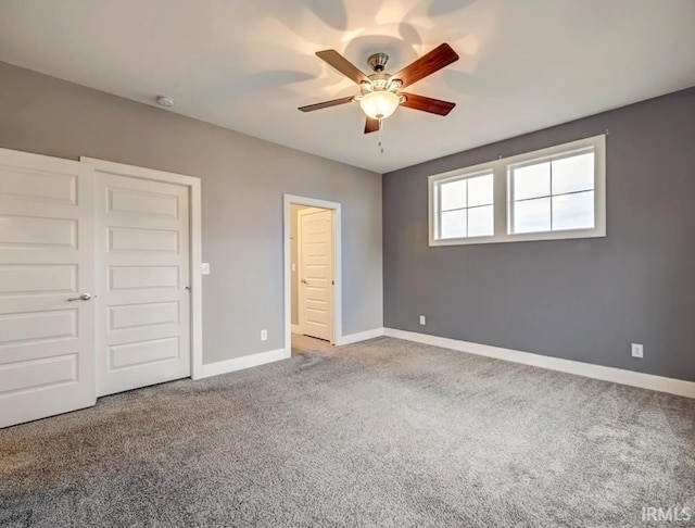 unfurnished bedroom with ceiling fan and carpet floors