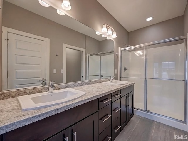 bathroom featuring vanity and a shower with shower door