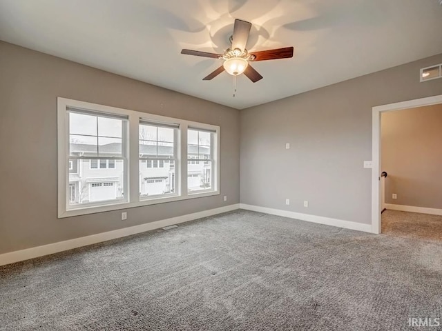 carpeted empty room featuring ceiling fan