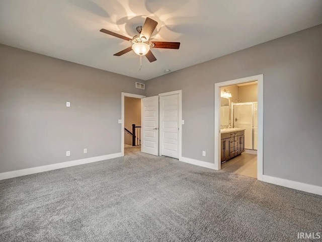 unfurnished bedroom with ceiling fan, light colored carpet, and ensuite bath