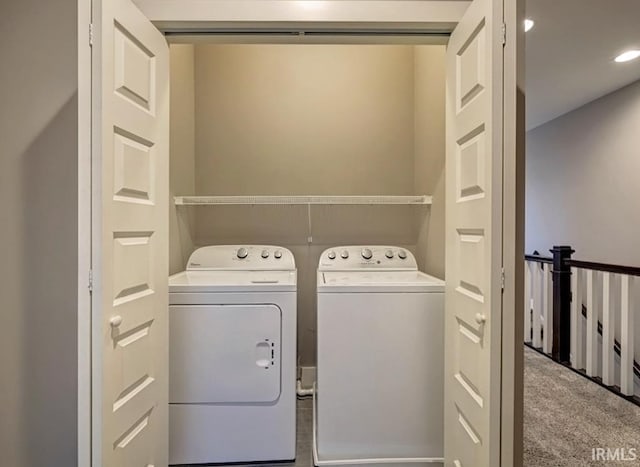 laundry area with light carpet and washing machine and clothes dryer