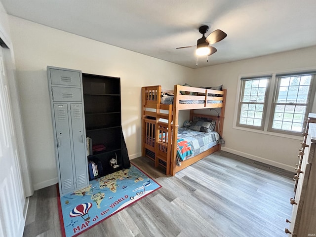 bedroom with hardwood / wood-style floors and ceiling fan