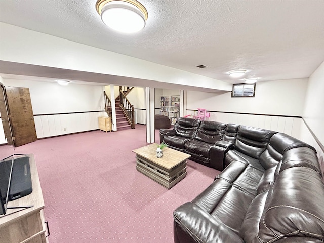 carpeted living room with a textured ceiling