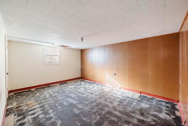 spare room featuring wood walls