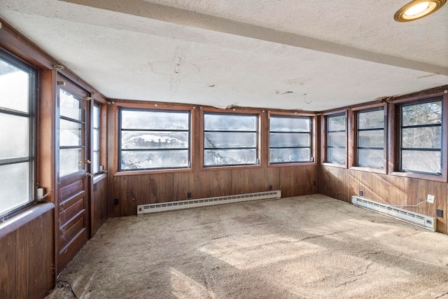 unfurnished sunroom with a baseboard heating unit