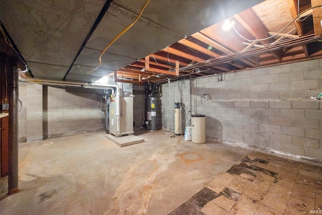 basement featuring water heater and heating unit