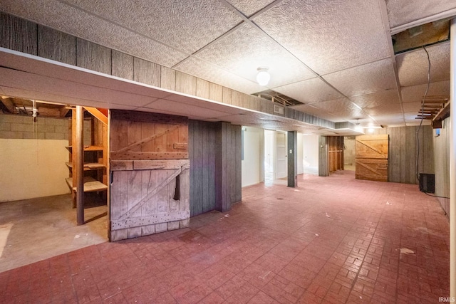 basement featuring a drop ceiling