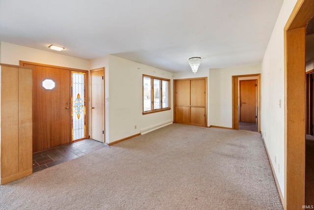 carpeted foyer featuring a baseboard heating unit