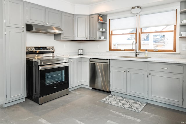 kitchen featuring gray cabinetry, sink, ornamental molding, and appliances with stainless steel finishes