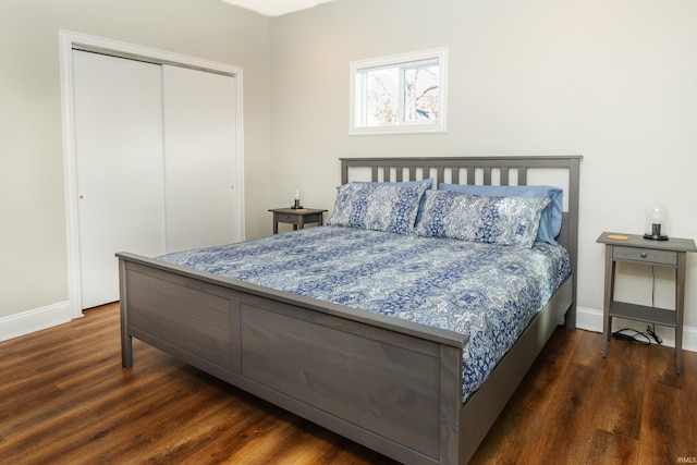 bedroom featuring dark hardwood / wood-style floors and a closet