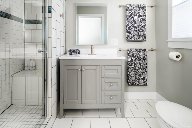 bathroom with vanity, toilet, tile patterned floors, and walk in shower