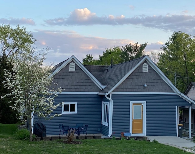 back house at dusk with a yard