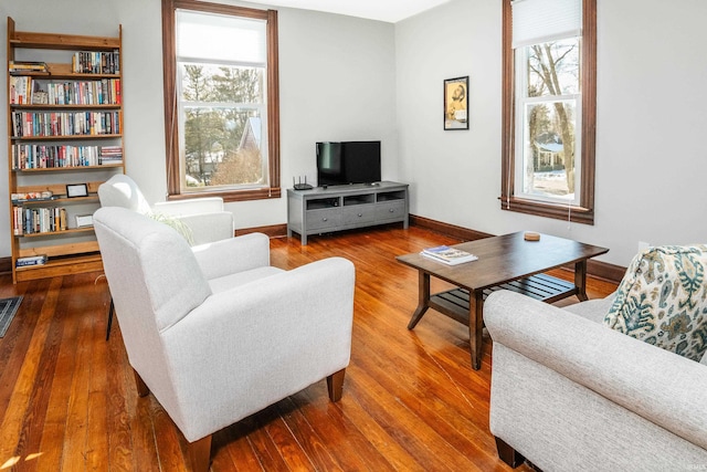 living room featuring plenty of natural light and dark wood-type flooring