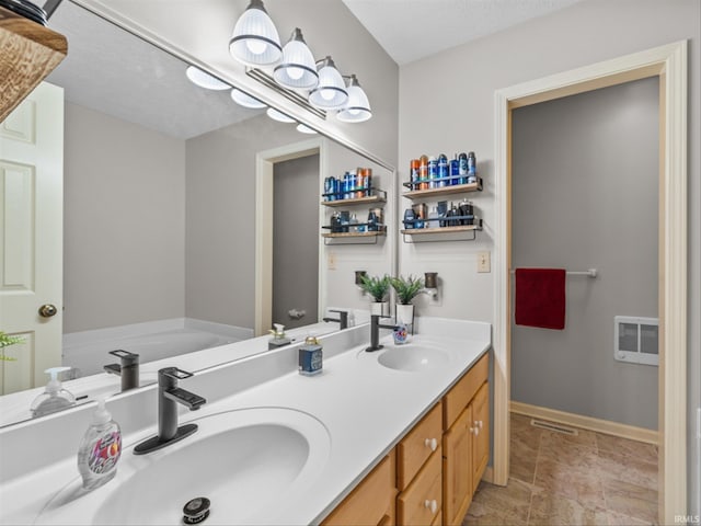 bathroom featuring vanity and a bathtub