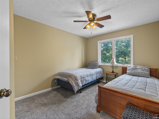 carpeted bedroom with a textured ceiling and ceiling fan